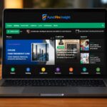 A laptop open on a desk displays the home page of a financial website called FundFireInsight.