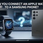 An Apple Watch sitting next to a Samsung Galaxy Ultra smartphone on a desk with a large, glowing question mark floating between them. The text at the top reads: "CAN YOU CONNECT AN APPLE WATCH TO A SAMSUNG PHONE?"