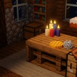 A cozy indoor Minecraft scene features a wooden table illuminated by colored candles, set against a backdrop of a nighttime window and bookshelves.